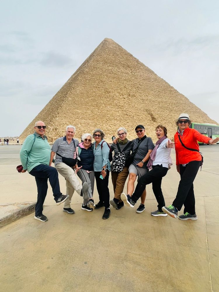 Magnificent Explorers guests posing together in front of the Great Pyramid at Giza